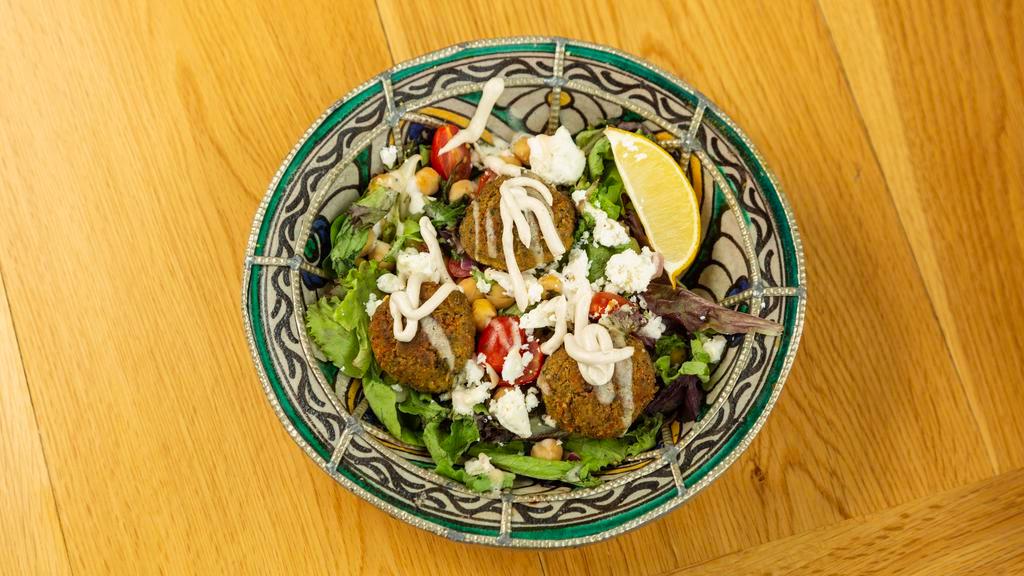 Falafel Salad · With cherry tomatoes, cucumbers, red onions, chickpeas and feta cheese, with lemon and extra virgin olive oil dressing