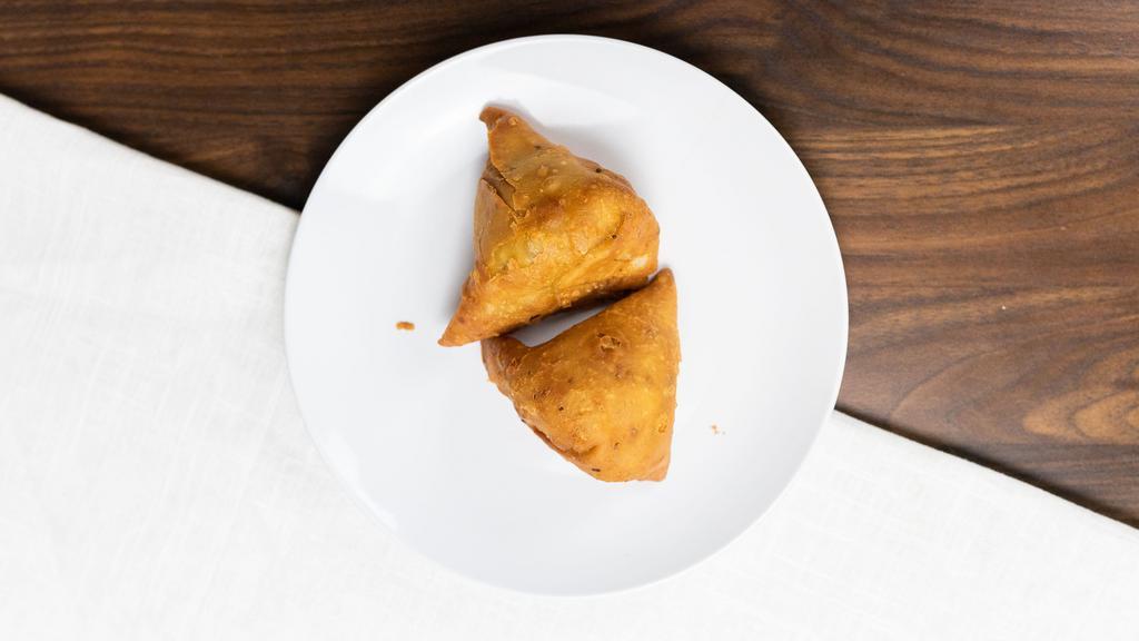 Veg Samosa · Crisply fried turnovers deliciously filled with mildly spiced potatoes and green peas.