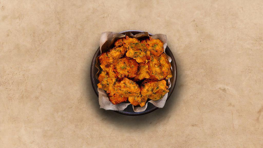 Veggie Pakoras  · 6 Pieces perfectly fried assortment of battered farm-fresh vegetables and herbs.