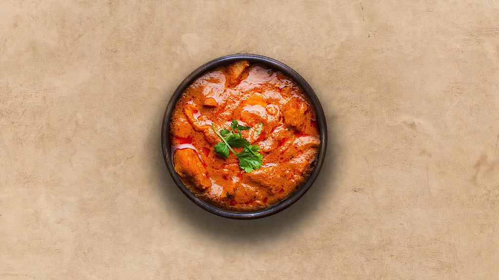 Tangy Chicken Tikka Masala · Oven-roasted chicken chunks in a rich creamy tomato and onion based gravy. Served with a portion of aromatic basmati rice.