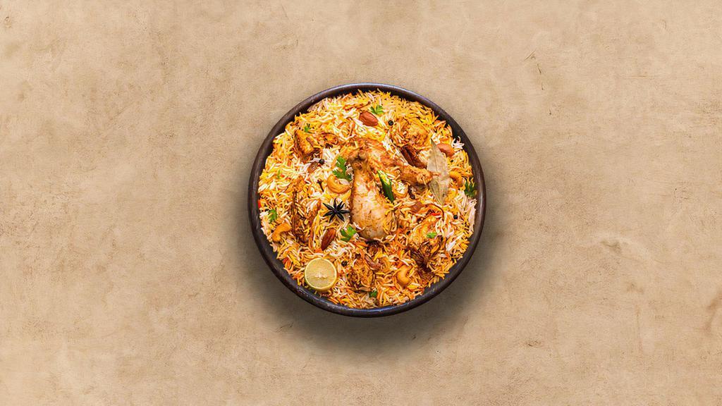 Spice Lane Chicken Biryani · Long grain basmati rice cooked with tender chicken and aromatic Indian herbs. Served with raita.