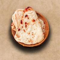 Plain Naan · Indian white flour flatbread baked to perfection in a traditional Indian clay oven.