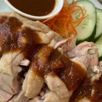 Chicken Over Rice (Kao Mun Gai) · Steamed chicken over ginger rice, cucumber, lettuce served with clear soup.