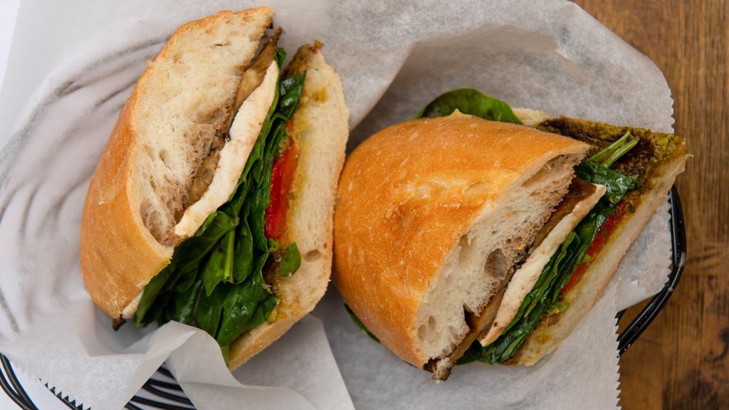 Savona · Fresh mozzarella, grilled eggplant, roasted peppers, pesto and baby spinach.