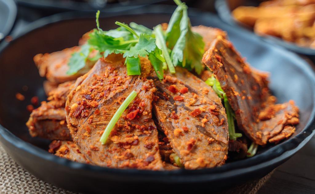 Beef In Chili Sauce · Marinated boiled beef, sliced and seasoned with salt, chili powder, Chinese celery and cilantro. Served cold.