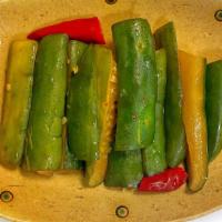 House Pickled Cucumbers · Marinated cucumber with a sour and sweet taste