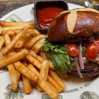 Sirloin & Brisket House Blend Burger · Grilled pretzel bun, Cajun remoulade, red onion, lettuce, cherry tomato, served with Cajun f...
