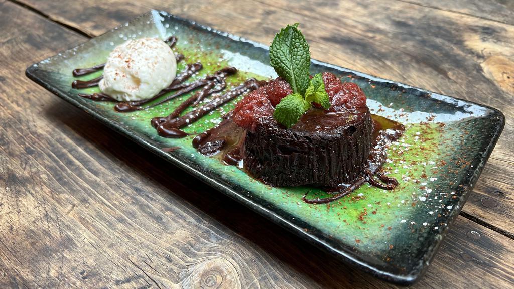Bourbon Infused Molten Chocolate Cake · Triple sec whipped cream, strawberry compote (gluten free)