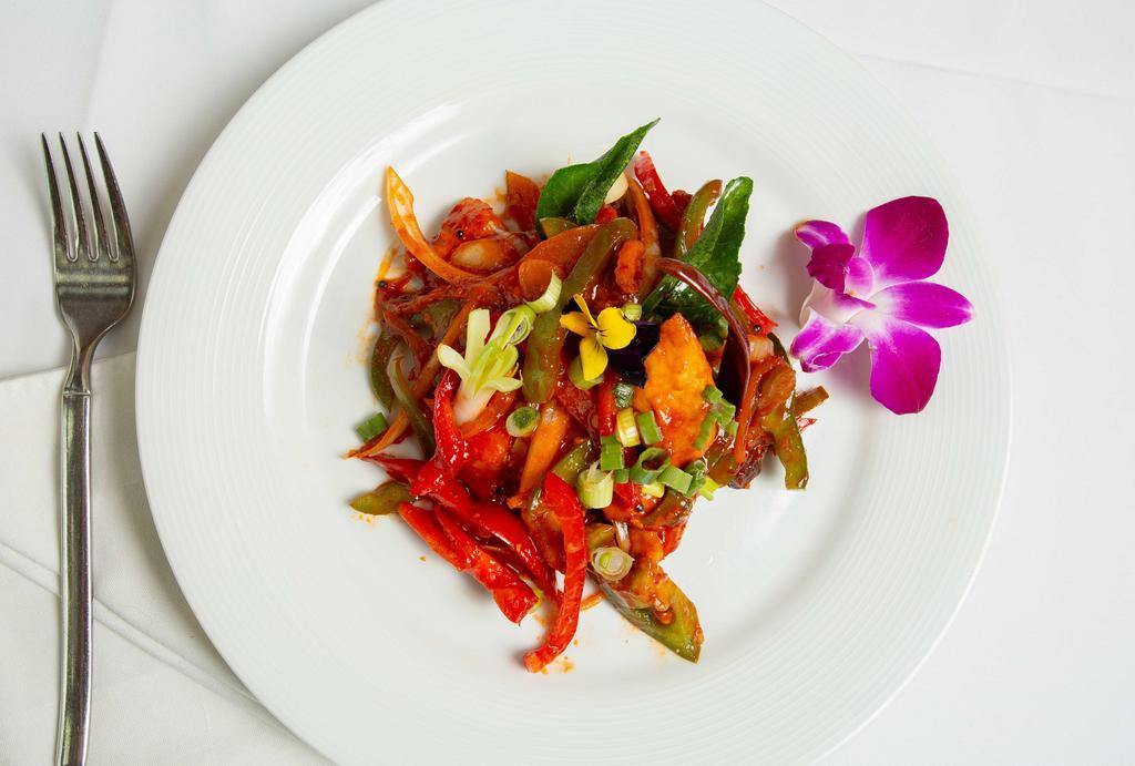 Andhra Chili Chicken · Spicy. Chicken strips tossed with bell pepper, onion, chili, soy sauce and curry leaves.