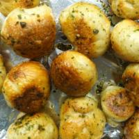 Garlic Knots (4) · A classic snack, our garlic knots are strips of pizza dough tied in a knot, baked, and then ...