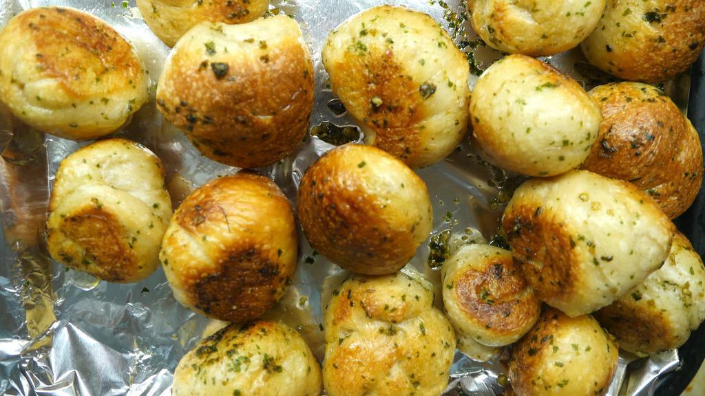 Garlic Knots (4) · A classic snack, our garlic knots are strips of pizza dough tied in a knot, baked, and then topped with melted butter, garlic, and parsley.