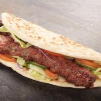 Kafta Kebab Sandwich · Delicious skewers of ground beef and lamb mixed with fresh parsley, onions, garlic and our h...