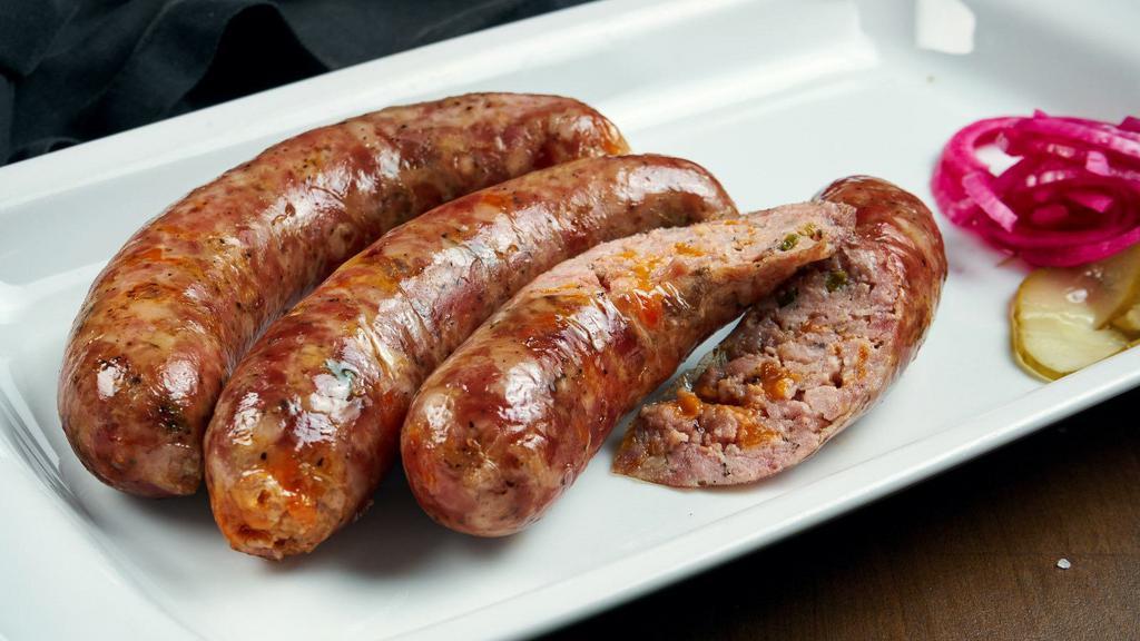 Makanek · Snappy sausages made with beef and Lebanese spices, grilled until crisp.