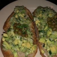 Avocado Bruschetta · Grilled bread with toppings.