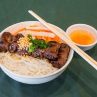 Bun Bo Lui · Grilled beef with sesame seasoning and lettuce on rice vermicelli.