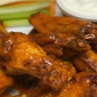 Classic Wings · Tossed in your choice of “mild” “medium”, or “inferno” sauce, served with blue cheese dippin...