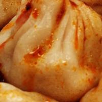Chicken Dumplings · Steamed or fried with ponzu and Thai chili dipping sauces.