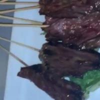 Hanger Steak Skewers · Grilled medium rare and served with a side of Peter Lugers sauce.
