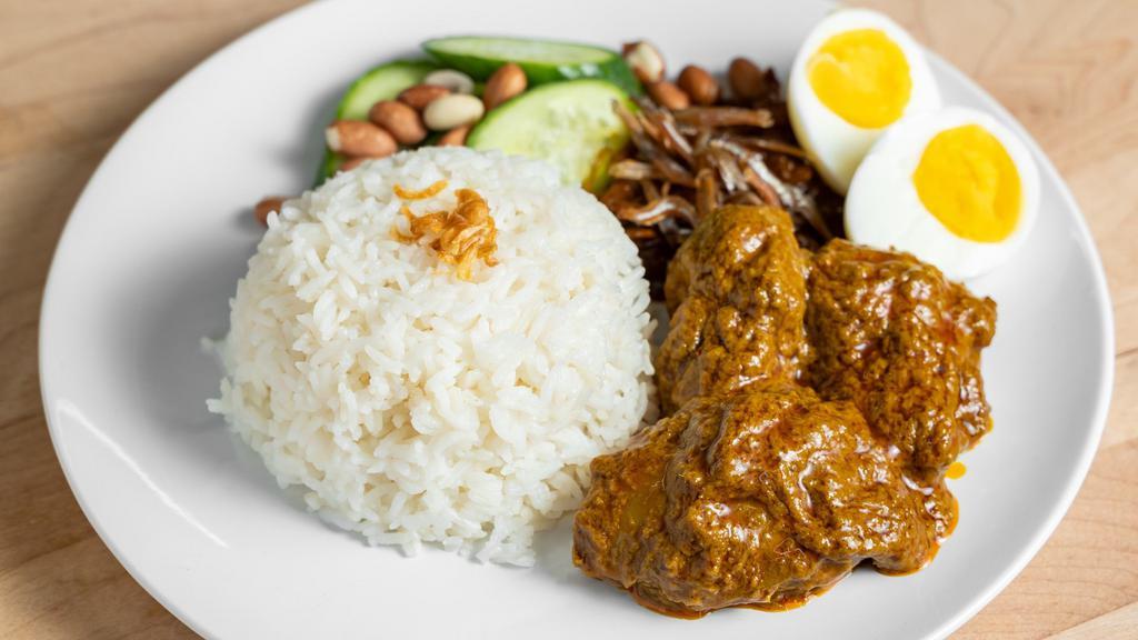 Lemak Rice With Chicken Curry · Coconut infused jasmine rice served with flavorful Malaysian chicken curry, roasted peanuts, fried anchovies sambal, egg and sliced cucumbers.