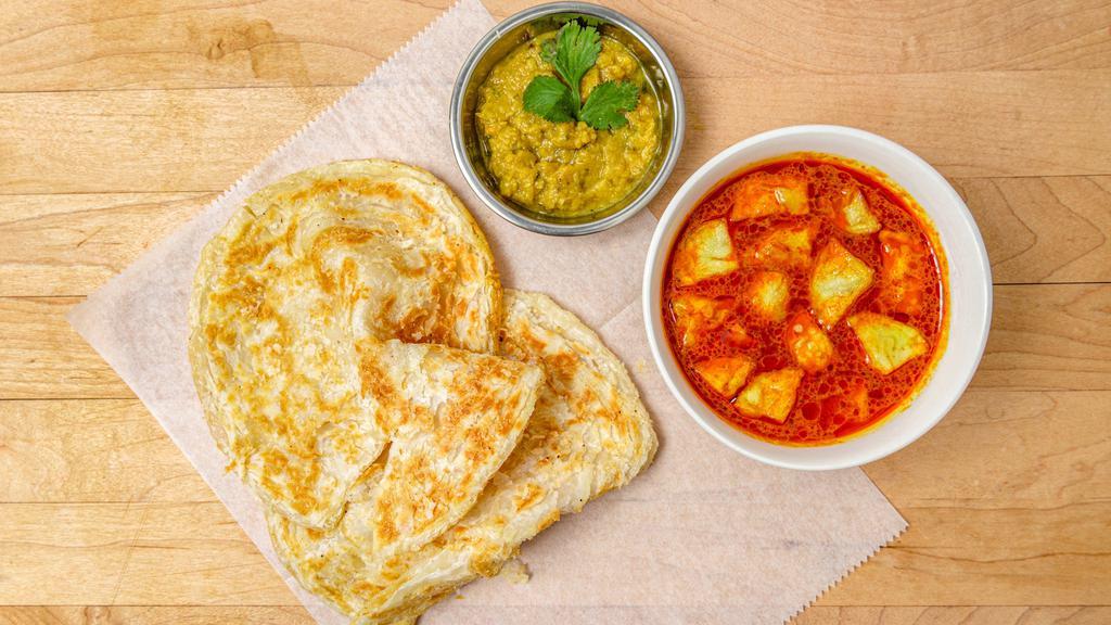Roti Canai · 2 fluffy layered pan fried bread served with Malaysian potato curry and dhal.