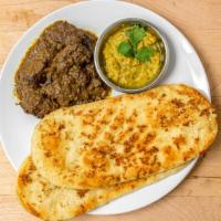 Garlic Naan With Beef Rendang · Garlic naan bread served with Malaysian chicken curry and dhal