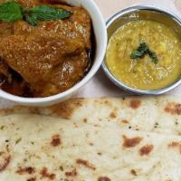 Garlic Naan With Chicken Curry · Garlic naan bread served with Malaysian chicken curry and dhal.