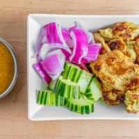 Chicken Satay · Grilled chicken slices marinated lemongrass, galangal, turmeric and spices served with delic...