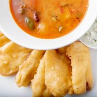Bhaji · Six pieces. Dipped in chickpeas flour with spices and served with sambar and chutney.