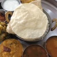 South Indian Thali · White rice, variety rice, sambar, rasam, three south Indian curries, curd, pickle, pappadam,...