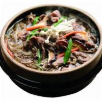 Bulgogi Ddukbaegi Soup · Thinly sliced prime marinated beef ribeye casserole with rice cake and glass noodle and mush...