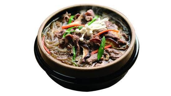 Bulgogi Ddukbaegi Soup · Thinly sliced prime marinated beef ribeye casserole with rice cake and glass noodle and mushroom served in a sizzling hot pot.