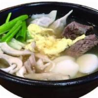 Galbi Dduk Mandoo Gook Soup · Prime beef short rib soup with homemade beef and pork dumplings and rice cake.