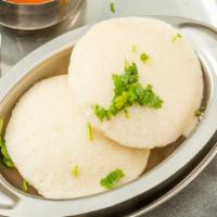 Idli · Steamed lentil and rice patties served with sambar and coconut chutney.