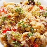 Papdi Chaat · House made wheat crispies layered with chickpeas, chopped raw red onions yogurt and dressed ...