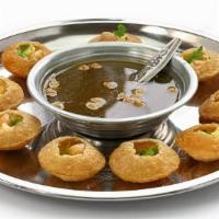 Pani Puri · Crispy shells with lentils and potatoes served with cold spicy tangy water on the side.