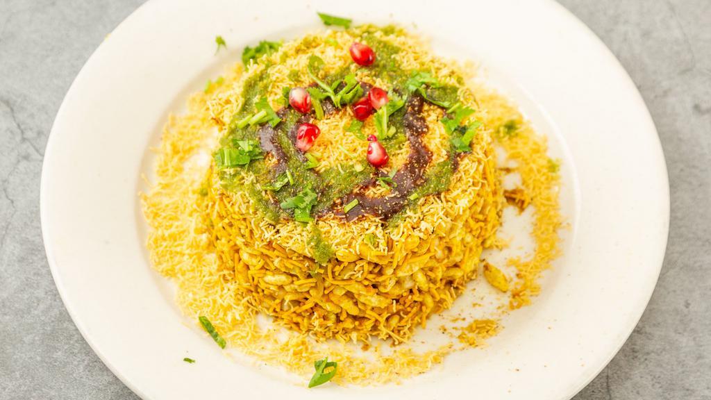 Bombay Bhel Puri · Puffed rice flakes tossed with onions, potatoes, tomatoes, cilantro and tamarind chutney, sprinkled with sev and pomegranate.