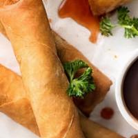 Vegetable Spring Roll · Golden fried crispy spring rolls served with a sweet chili sauce.