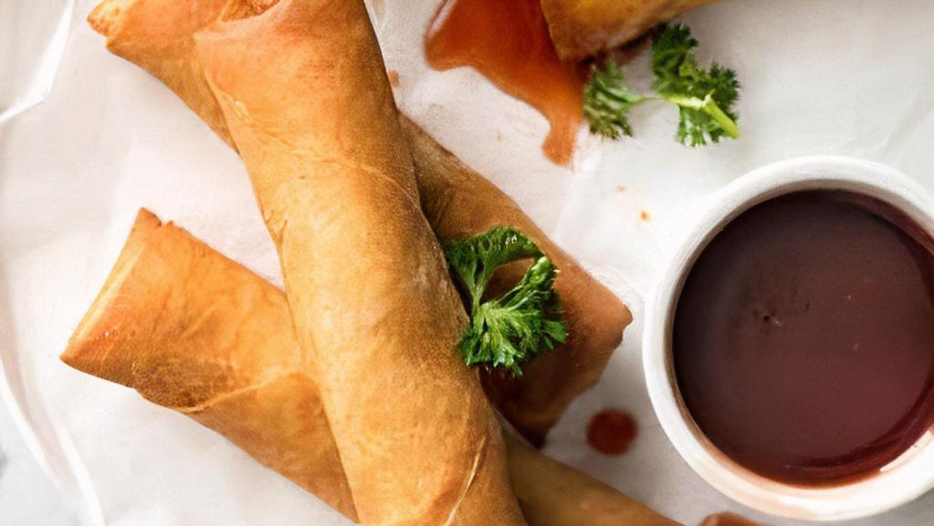 Vegetable Spring Roll · Golden fried crispy spring rolls served with a sweet chili sauce.