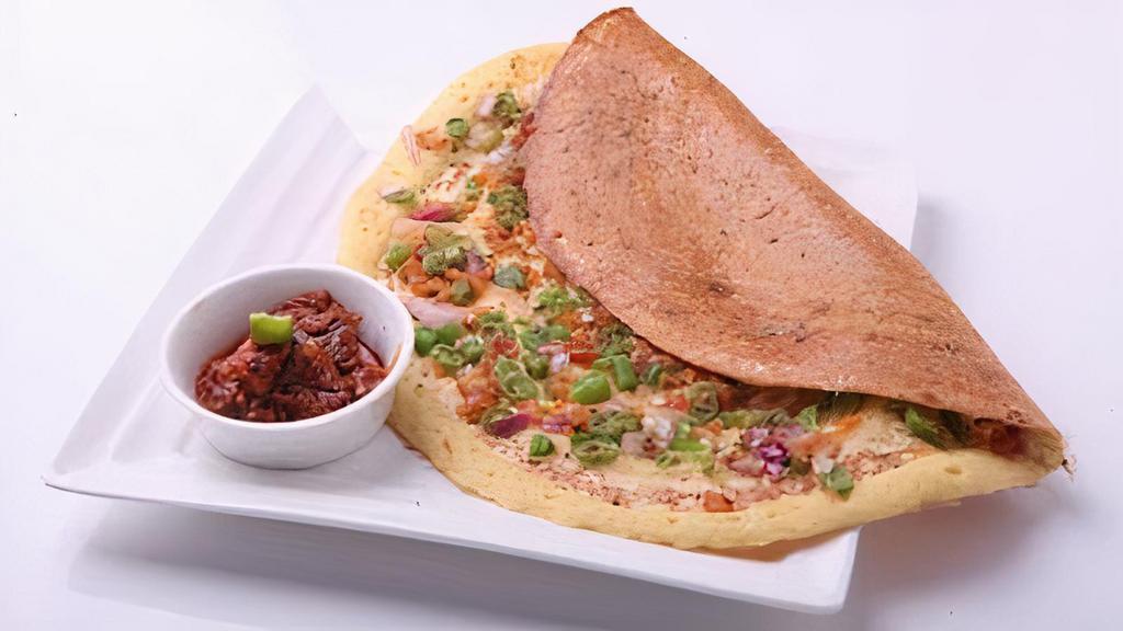 Occ Masala Dosa · Plain dosa with onions, green chillies, cheese and potatoes served with sambar and coconut chutney.