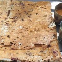 Special Rava Dosa · Rava Dosa with red onions and green chillies served with sambar and coconut chutney.