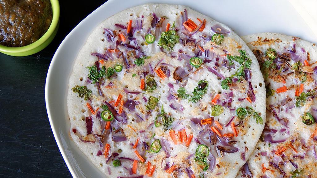 Onion & Chilli Uttapam · Topped with fresh onions and chillies served with sambar and coconut chutney.