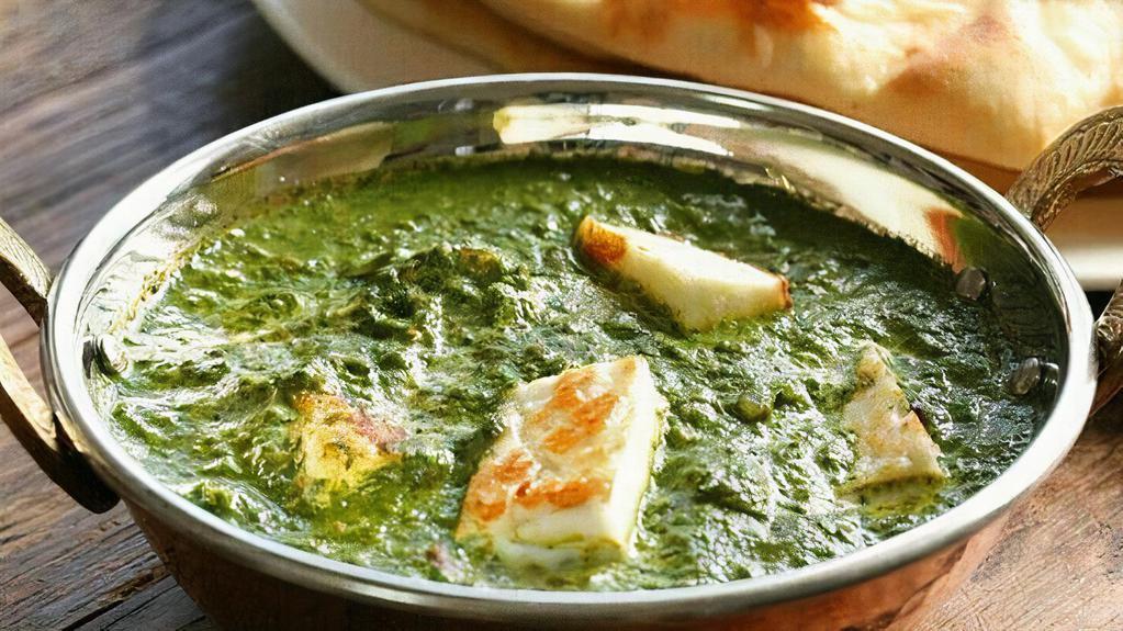 Palak Paneer · Cubes of homemade cottage cheese cooked with Spinach in a tomato based gravy, finished with butter and topped with cream.