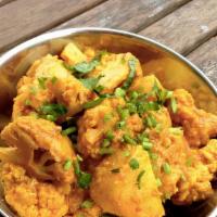 Aloo Gobi · Cauliflower and potatoes seasoned with ginger, garlic, herbs, and spices.