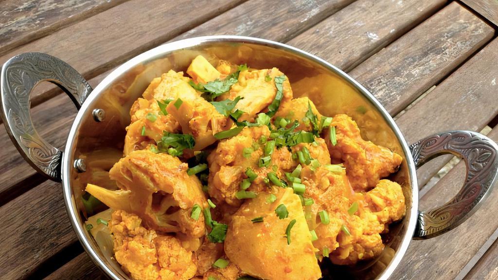 Aloo Gobi · Cauliflower and potatoes seasoned with ginger, garlic, herbs, and spices.
