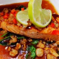 Salmon In The Sea · Served with minced shrimp, scallops, shallots, and garlic. Served with sautéed spinach.
