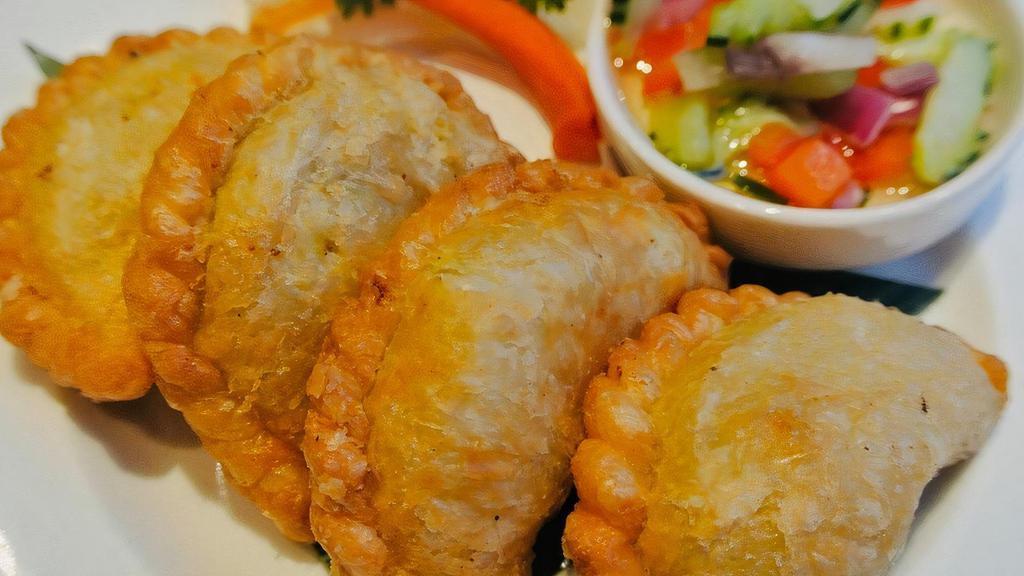 Curry Puff · Most popular. Fried puff pastry stuffed with chicken, sweet potatoes, carrots, onion, and yellow curry powder. Served with cucumber salad.