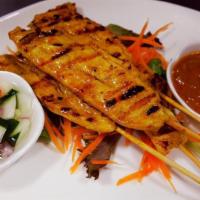 Chicken Satay · Grilled marinated chicken with yellow curry powder. Served with peanut sauce and cucumber sa...