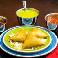 Vege / Meat Samosas · Crispy turnover stuffed with a choice of vegetable or ground lamb.