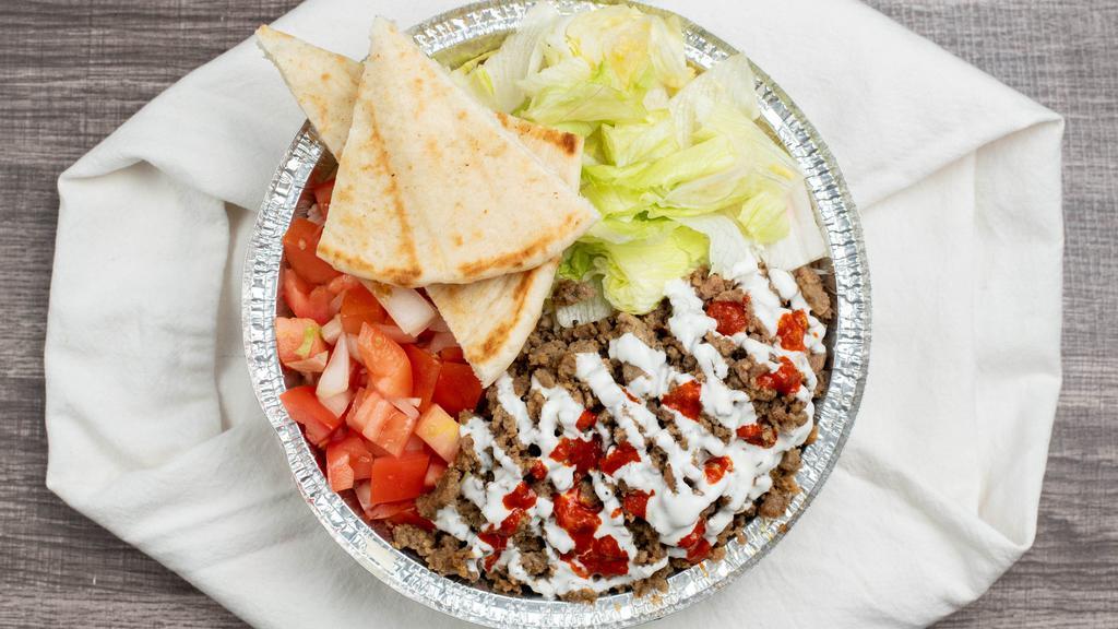 Chicken N Lamb Gyro Over Rice Platter · Take your taste buds to a journey of ancient Greece with juicy beef gyro and grilled chicken over rice with lettuce, and tomatoes coupled with white sauce and hot sauce on the side.