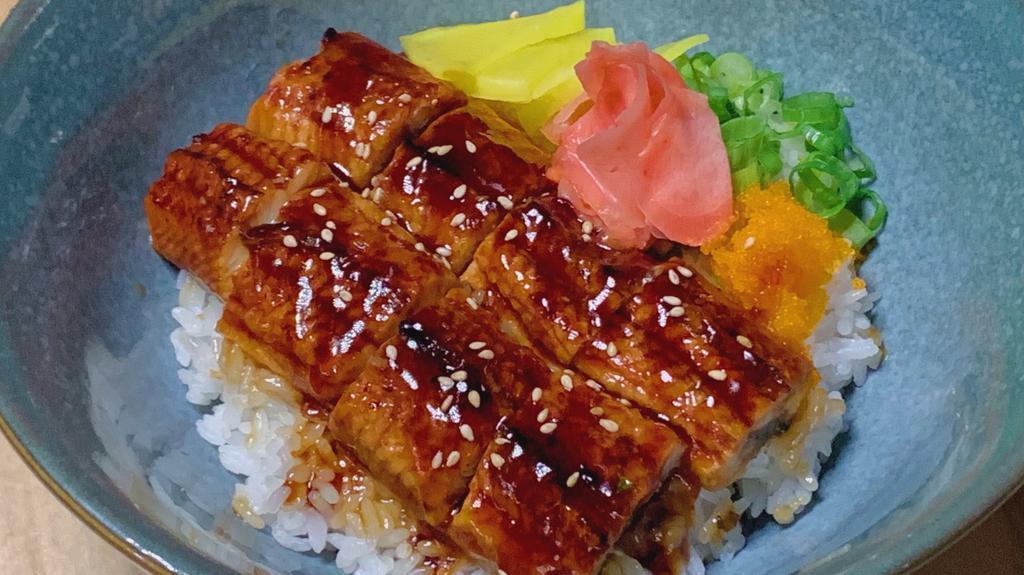 Unagi (Eel) Rice Box · Broiled Eel with Eel Sauce, Sesame Seeds, Pickled Radish, Pickled Ginger, and Green Onion over White Rice.